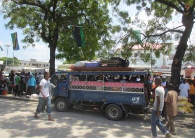 A group of people riding on the back of a truck