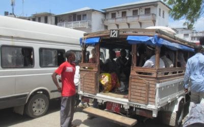 A group of people standing in front of a truck