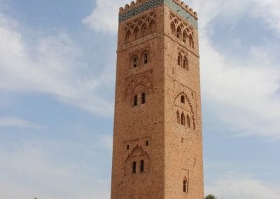 A large clock tower in front of Koutoubia Mosque