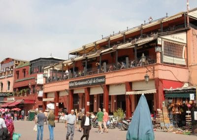 A group of people walking in front of a building