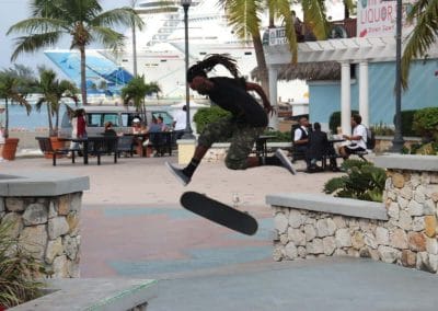 A man jumping in the air doing a trick on a skateboard