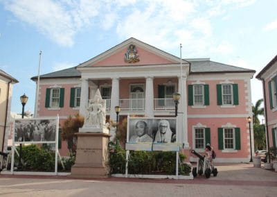 A close up of a street in front of a pink house