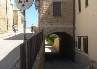 A large brick building with a sign on the side of a road