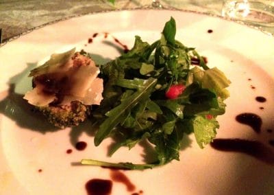 A white plate topped with meat and vegetables