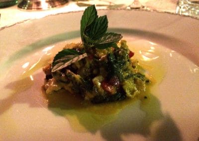 A white plate topped with meat and vegetables