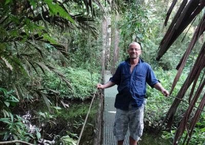 A man standing next to a tree