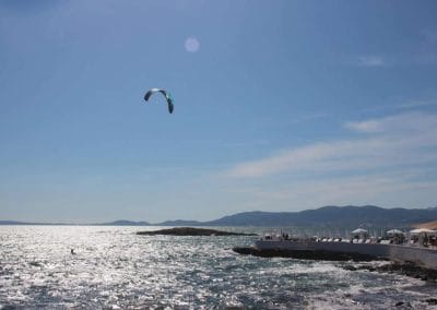 A man flying kite in a body of water