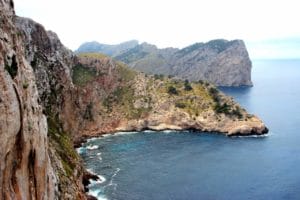 A rocky island in the middle of a body of water