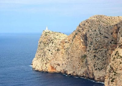 A rocky island in the middle of a body of water