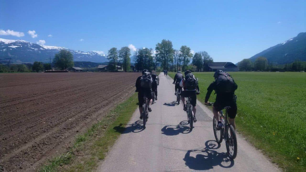 A person riding a bike down a dirt road