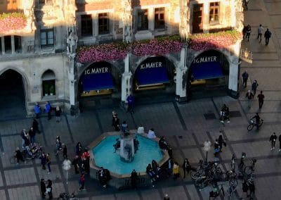 A group of people walking in front of a building