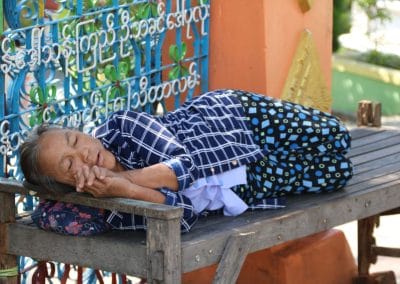 A person sitting on a wooden bench