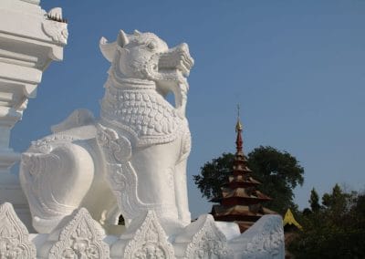 A statue in front of a cake