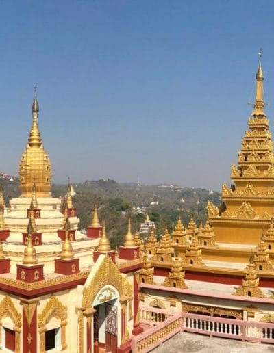A large building with Sule Pagoda in the background