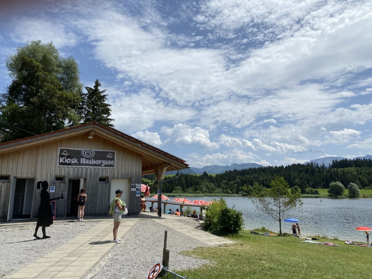 Kiosk mit Bergsee, Wald Und Menschen