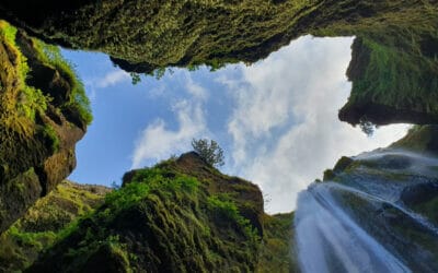 Green mountain under white clouds